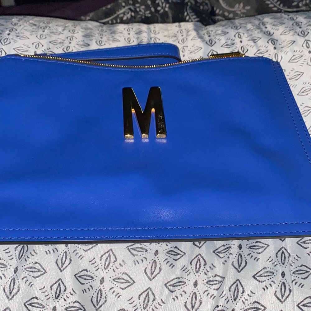This wristlet is a beautiful blue cute and and convenient 100% authentic